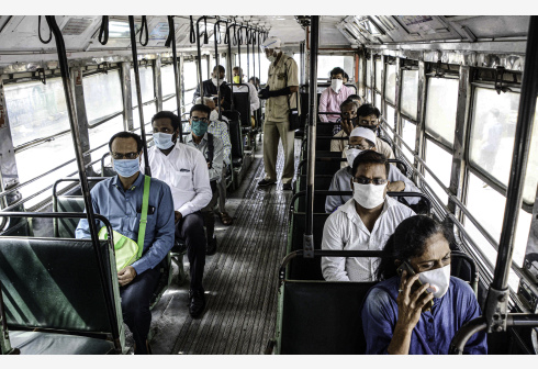 6月9日，佩戴口罩的乘客在印度孟买乘坐公共汽车。? 新华社 图